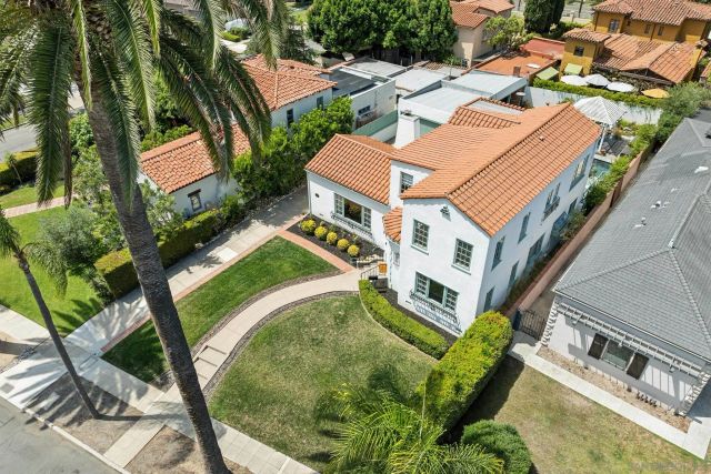 an aerial view of multiple houses with yard