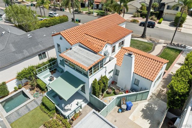an aerial view of a house with garden space and street view