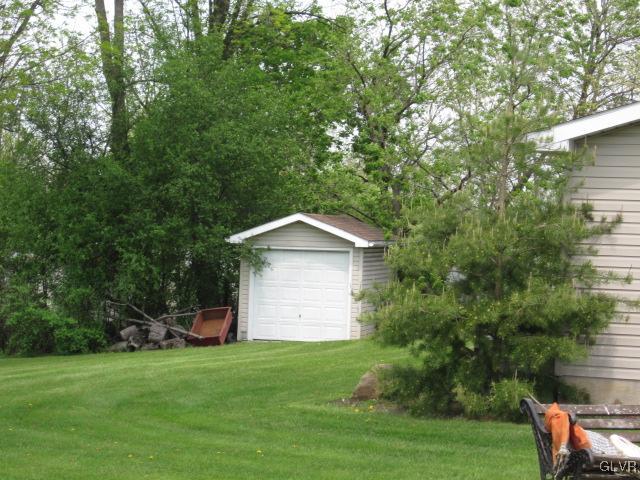4759 Grammes Road Allentown, PA 18104 - Photo 5 of 14 a view of a wooden house with a yard and large trees