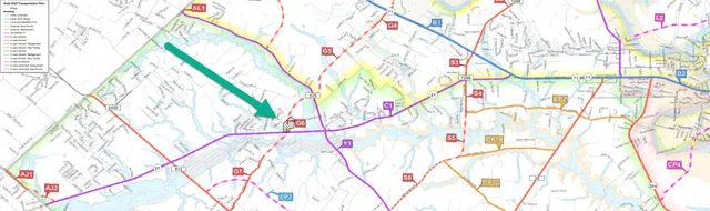 a white bed with a white comforter and chair