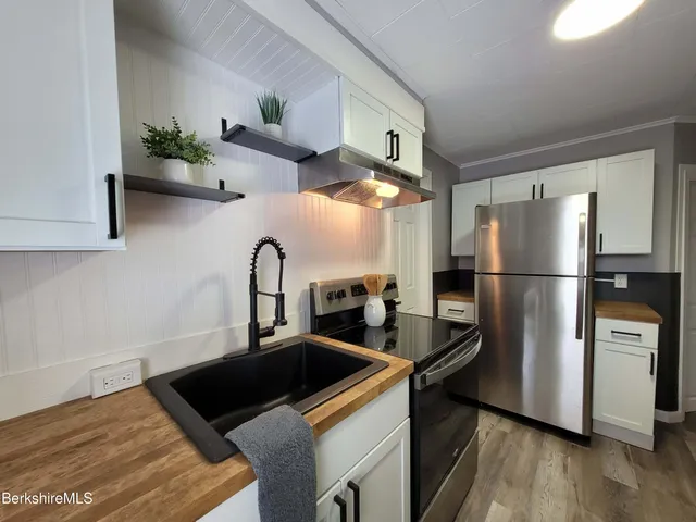 a kitchen with a refrigerator and a sink