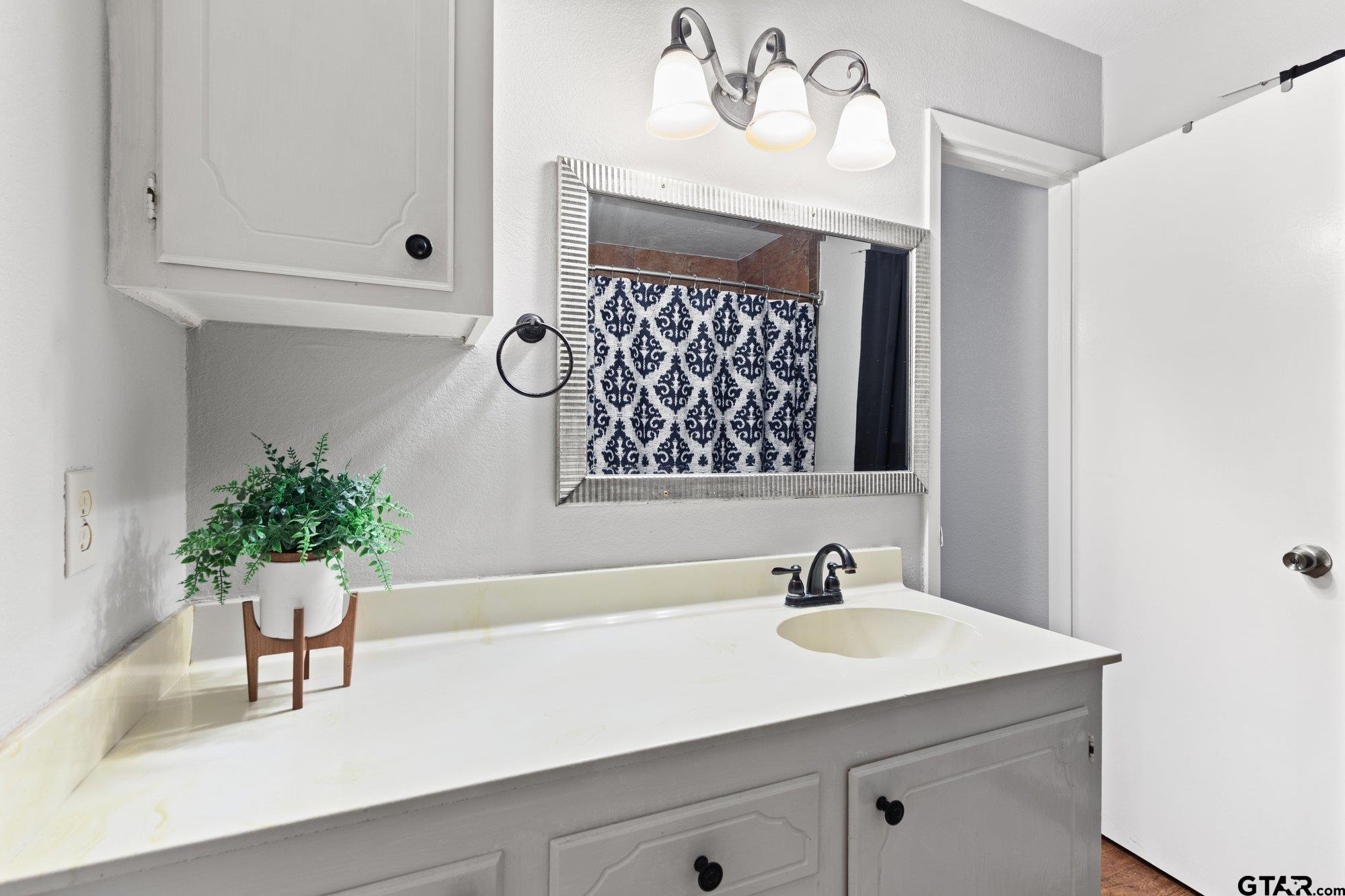 128 Amy Street Longview, TX 75605 - Photo 15 of 21 a bathroom with a sink and a mirror