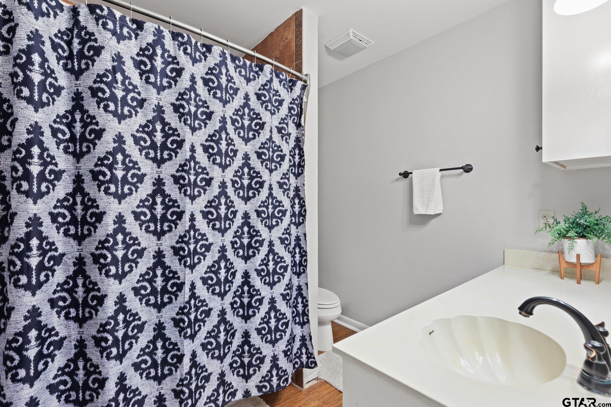 128 Amy Street Longview, TX 75605 - Photo 16 of 21 a bathroom with a bathtub and shower