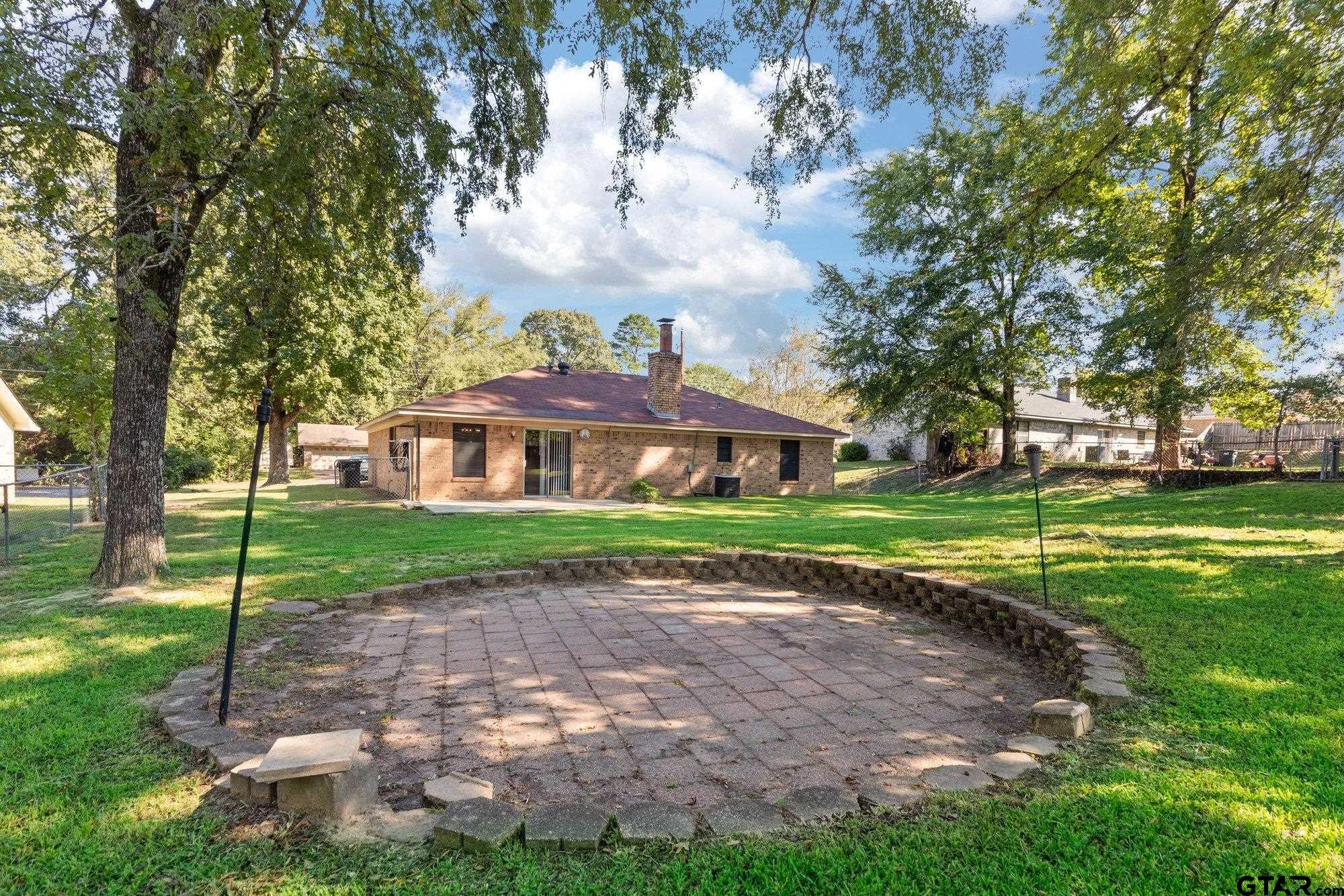 128 Amy Street Longview, TX 75605 - Photo 17 of 21 a view of house in front of a big yard with large trees