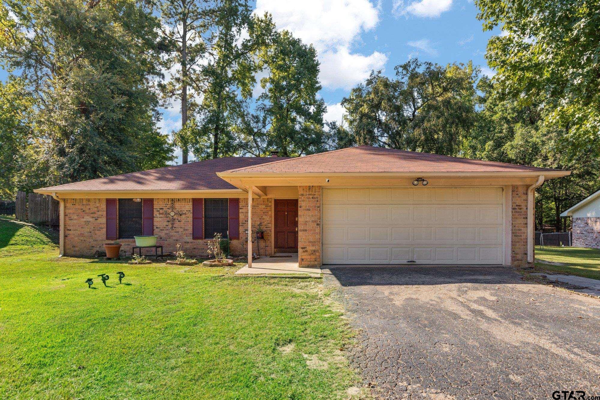 128 Amy Street Longview, TX 75605 - Photo 2 of 21 a front view of house with yard and trees in the background