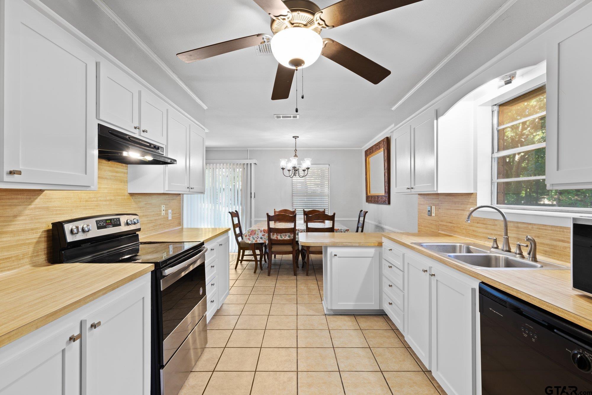 128 Amy Street Longview, TX 75605 - Photo 3 of 21 a kitchen with a sink stainless steel appliances and window
