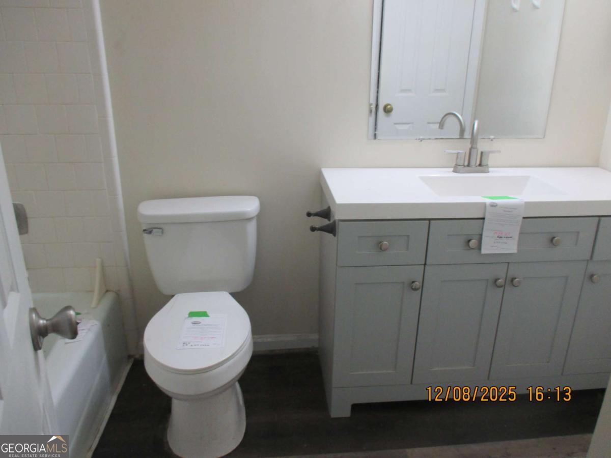 908 Kings Road Hinesville, GA 31313 - Photo 9 of 15 a bathroom with a toilet sink and mirror