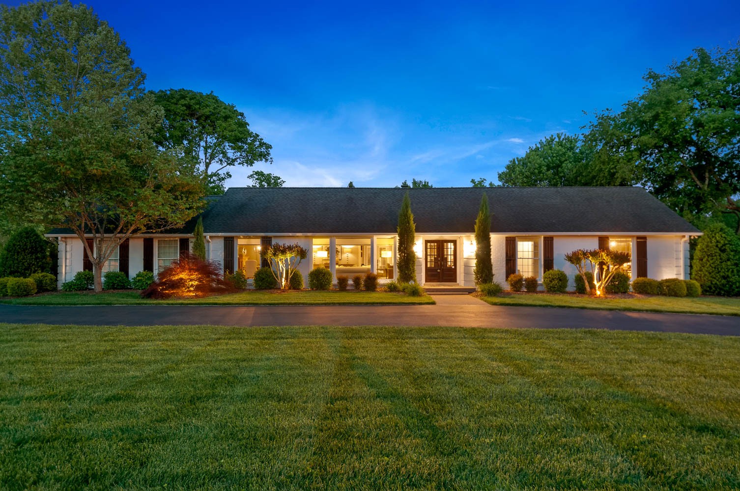 a view of swimming pool is middle in the grass