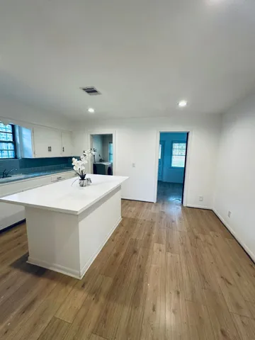 a view of kitchen with wooden floor and electronic appliances