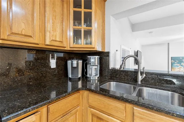 a kitchen with a stove and chairs