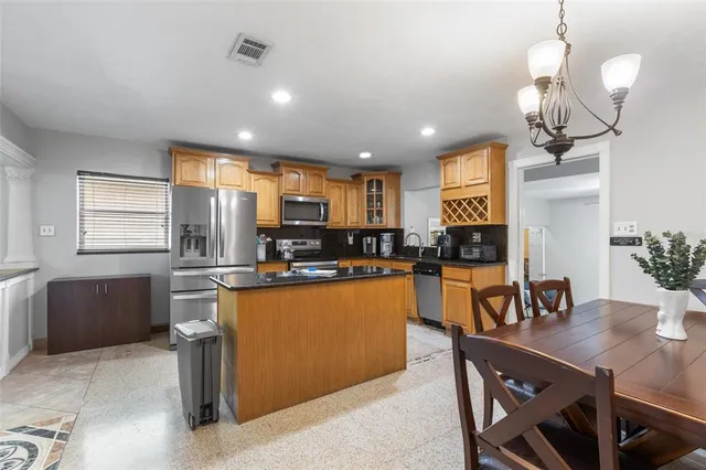 a kitchen with a stove and a refrigerator