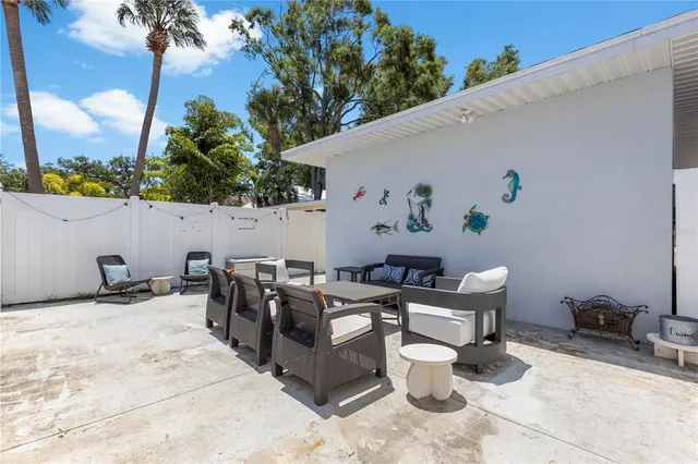 a view of a house with pool and sitting area