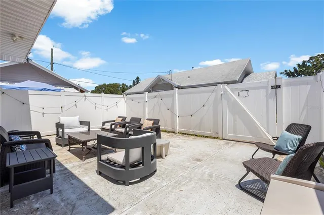 a view of a workspace with furniture and window