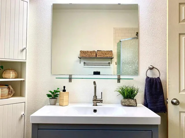 a bathroom with a sink and a mirror