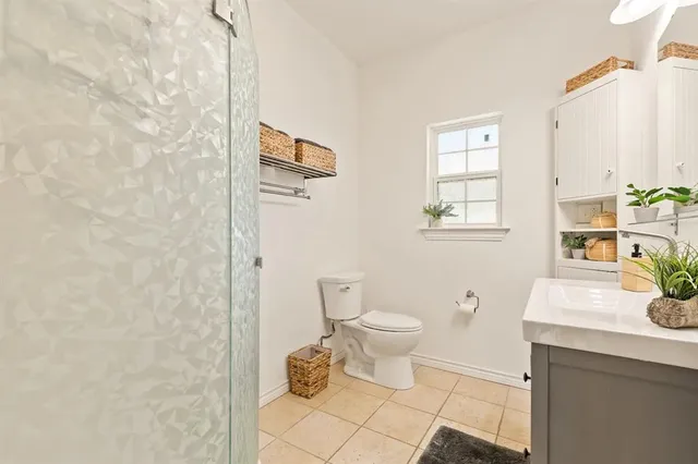 a bathroom with a toilet a sink and a mirror