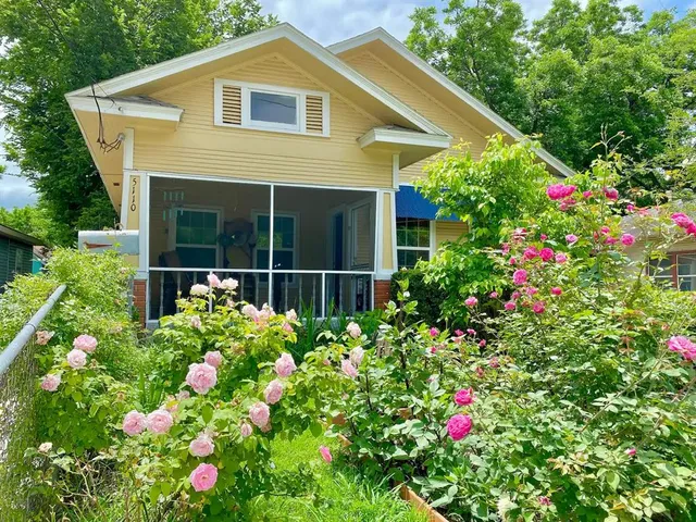 a house with flowers in front of it