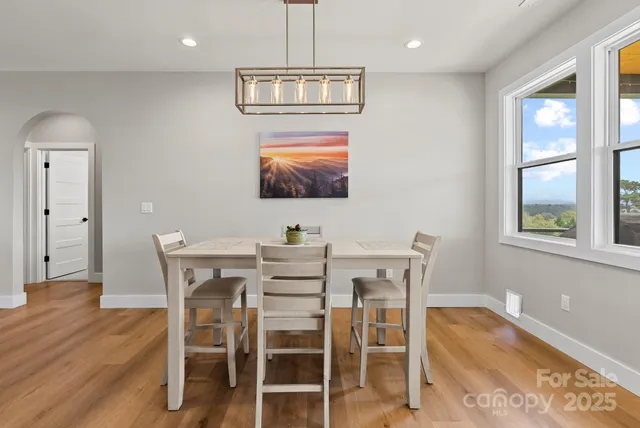 a view of a dining room with furniture window and wooden floor