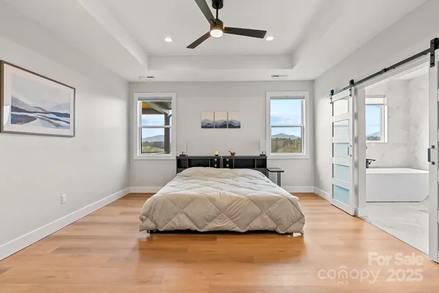 a bedroom with a large bed and a chandelier