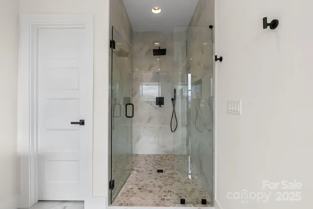 a bathroom with a glass shower door