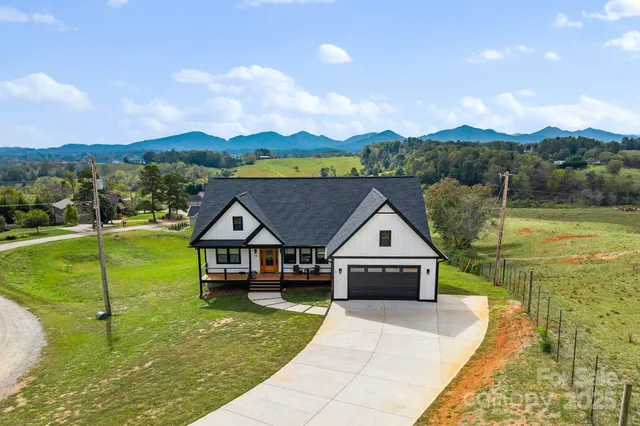 a front view of a house with a garden and yard