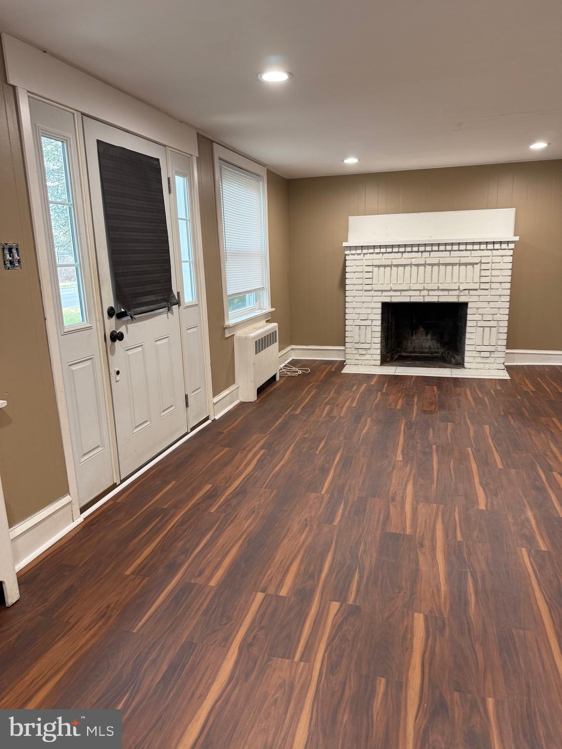 1482 Glassboro Road, Unit A Wenonah, NJ 08090 - Photo 2 of 12 a view of empty room with wooden floor and fireplace