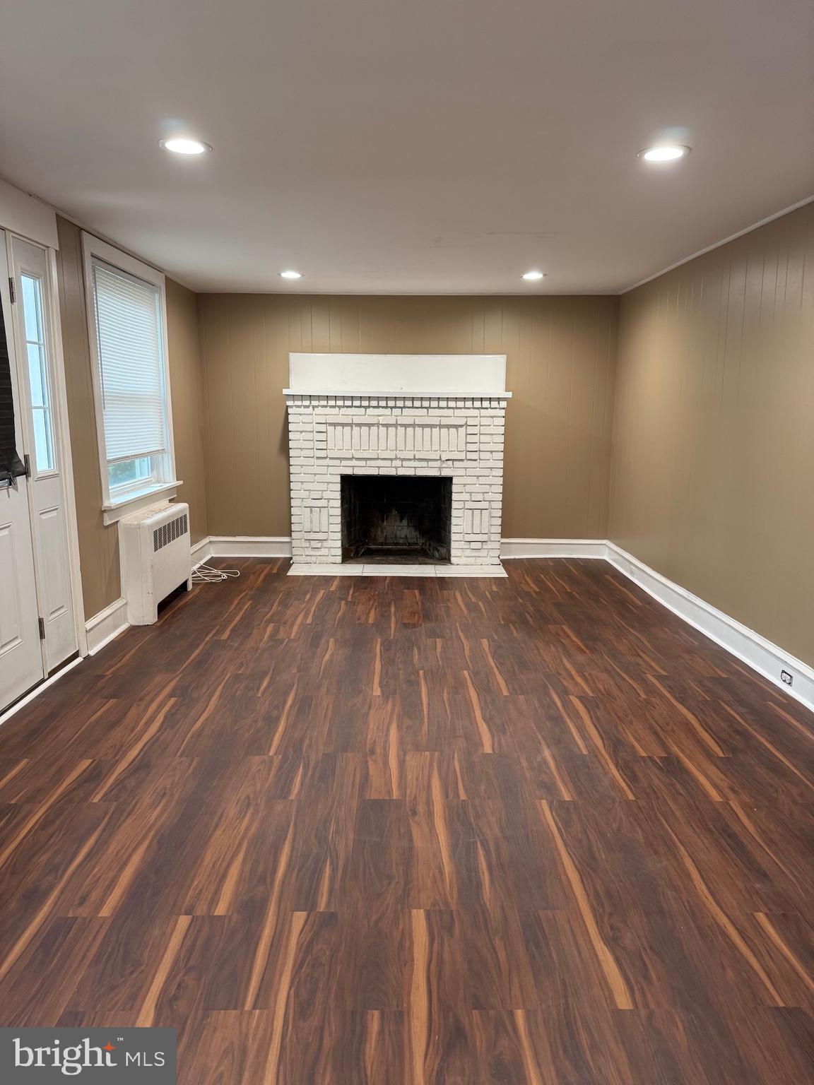 1482 Glassboro Road, Unit A Wenonah, NJ 08090 - Photo 3 of 12 a view of empty room with wooden floor and fireplace