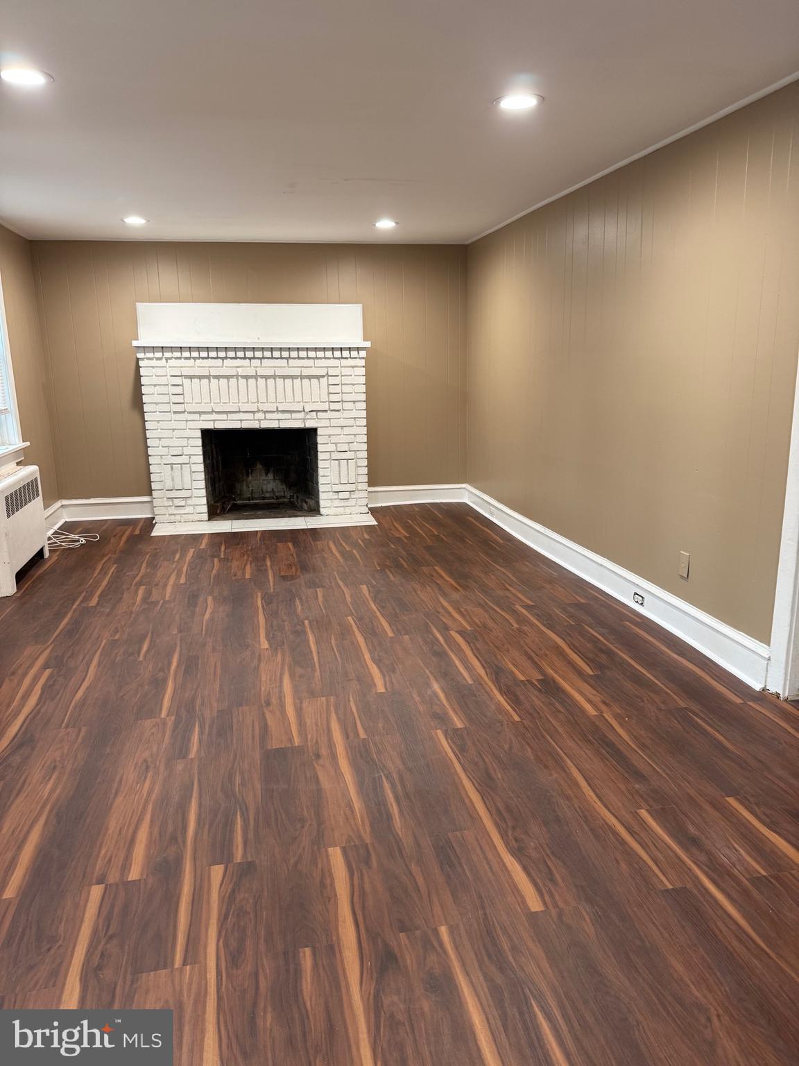 1482 Glassboro Road, Unit A Wenonah, NJ 08090 - Photo 4 of 12 a view of empty room with wooden floor and fireplace