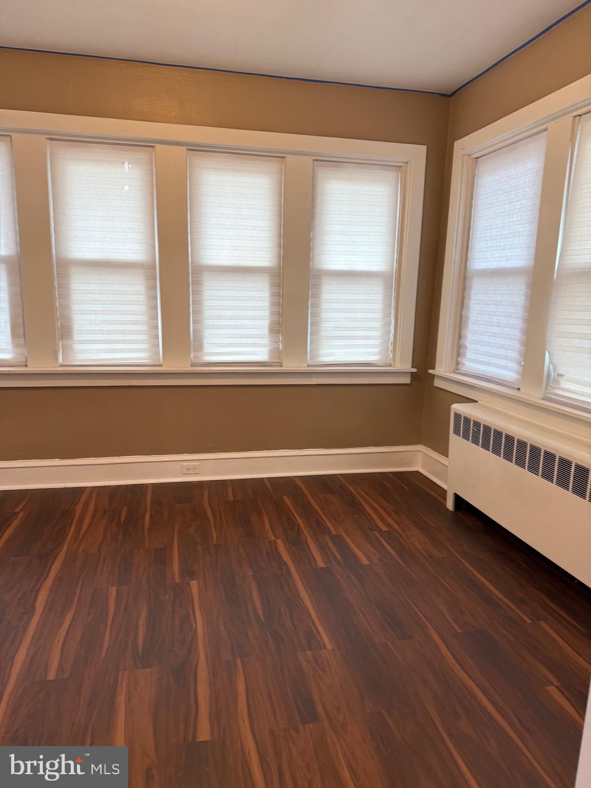 1482 Glassboro Road, Unit A Wenonah, NJ 08090 - Photo 6 of 12 a view of an empty room with wooden floor and a window