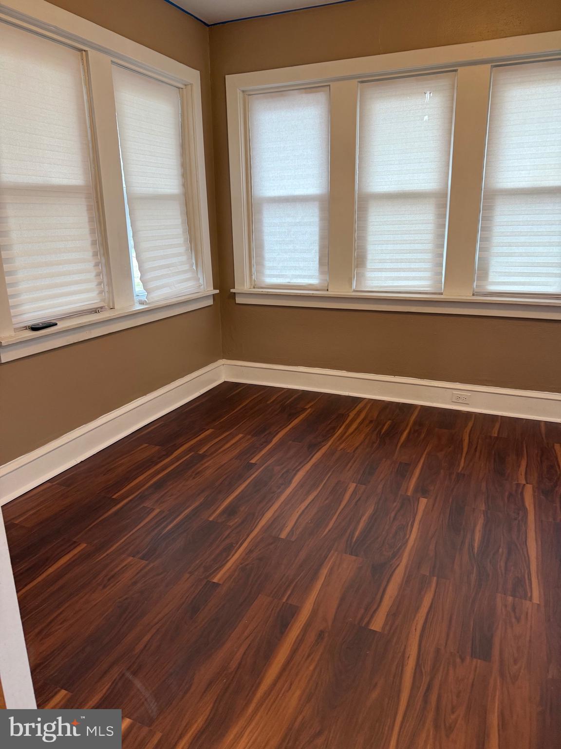1482 Glassboro Road, Unit A Wenonah, NJ 08090 - Photo 7 of 12 a view of an empty room with wooden floor and a window