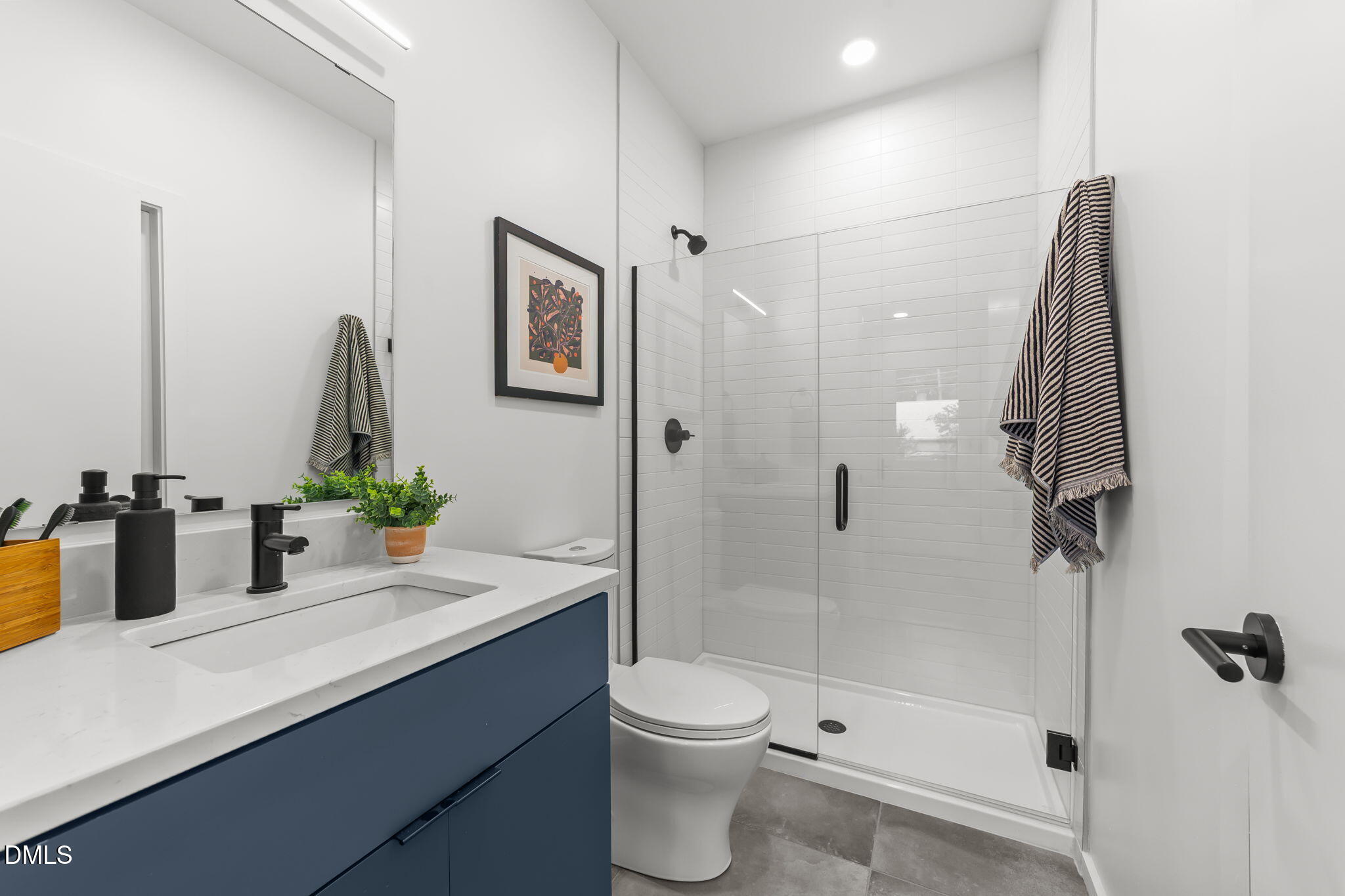 301 Clark Street Durham, NC 27701 - Photo 16 of 30 a bathroom with a double vanity sink toilet and shower