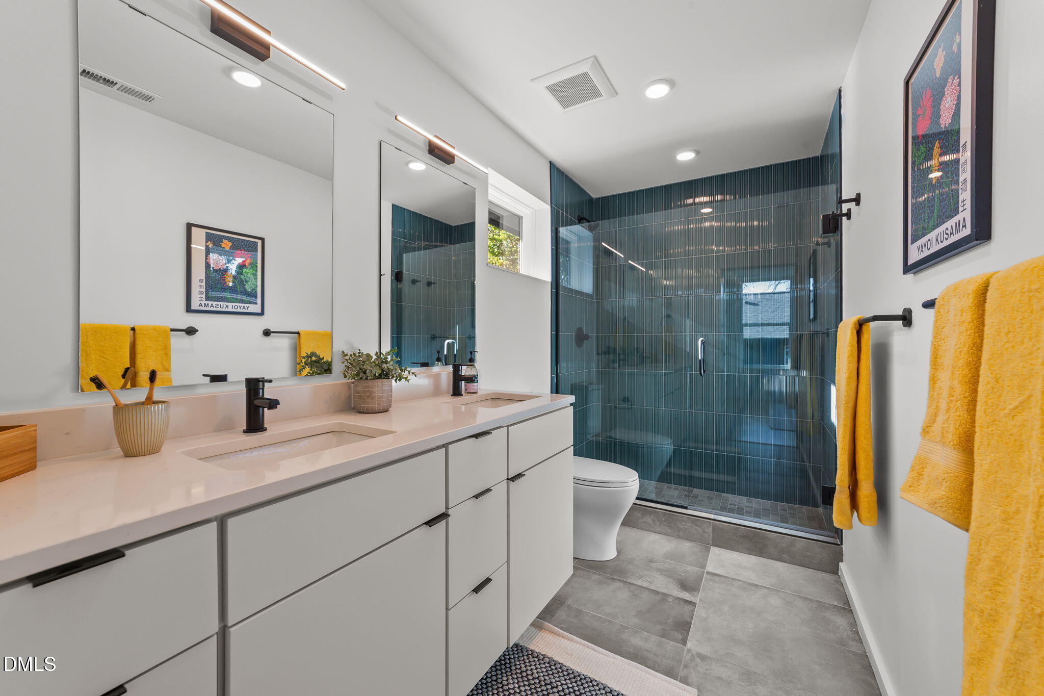 301 Clark Street Durham, NC 27701 - Photo 24 of 30 a bathroom with a double vanity sink toilet mirror and shower