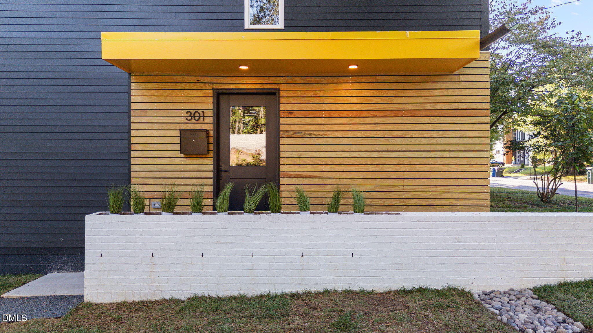 301 Clark Street Durham, NC 27701 - Photo 26 of 30 a view of a house with a yard and potted plants