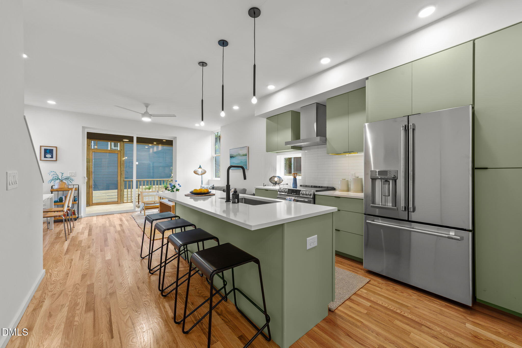 301 Clark Street Durham, NC 27701 - Photo 4 of 30 a kitchen with stainless steel appliances a dining table chairs stove refrigerator and cabinets