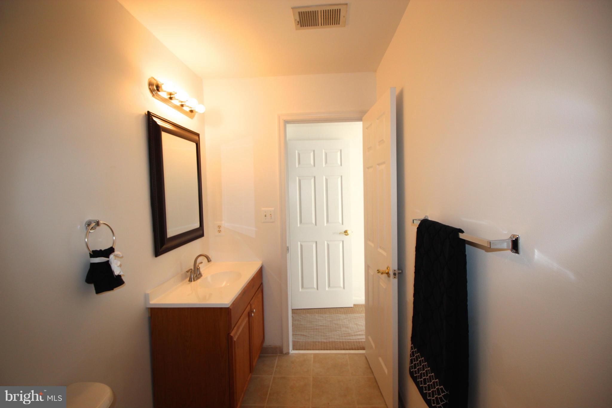 10556 Falkirk Way Manassas, VA 20109 - Photo 14 of 23 a bathroom with a sink and mirror