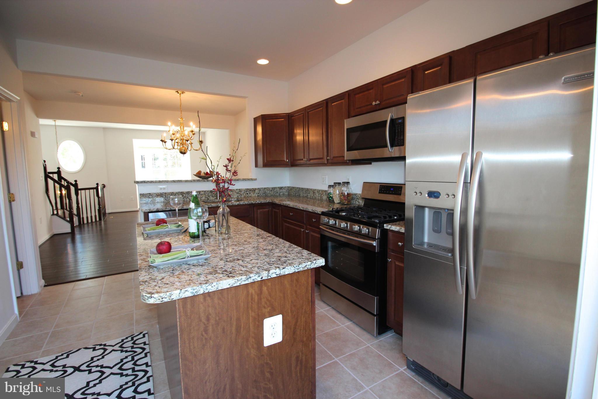 10556 Falkirk Way Manassas, VA 20109 - Photo 5 of 23 a kitchen with stainless steel appliances granite countertop a refrigerator a stove and a sink