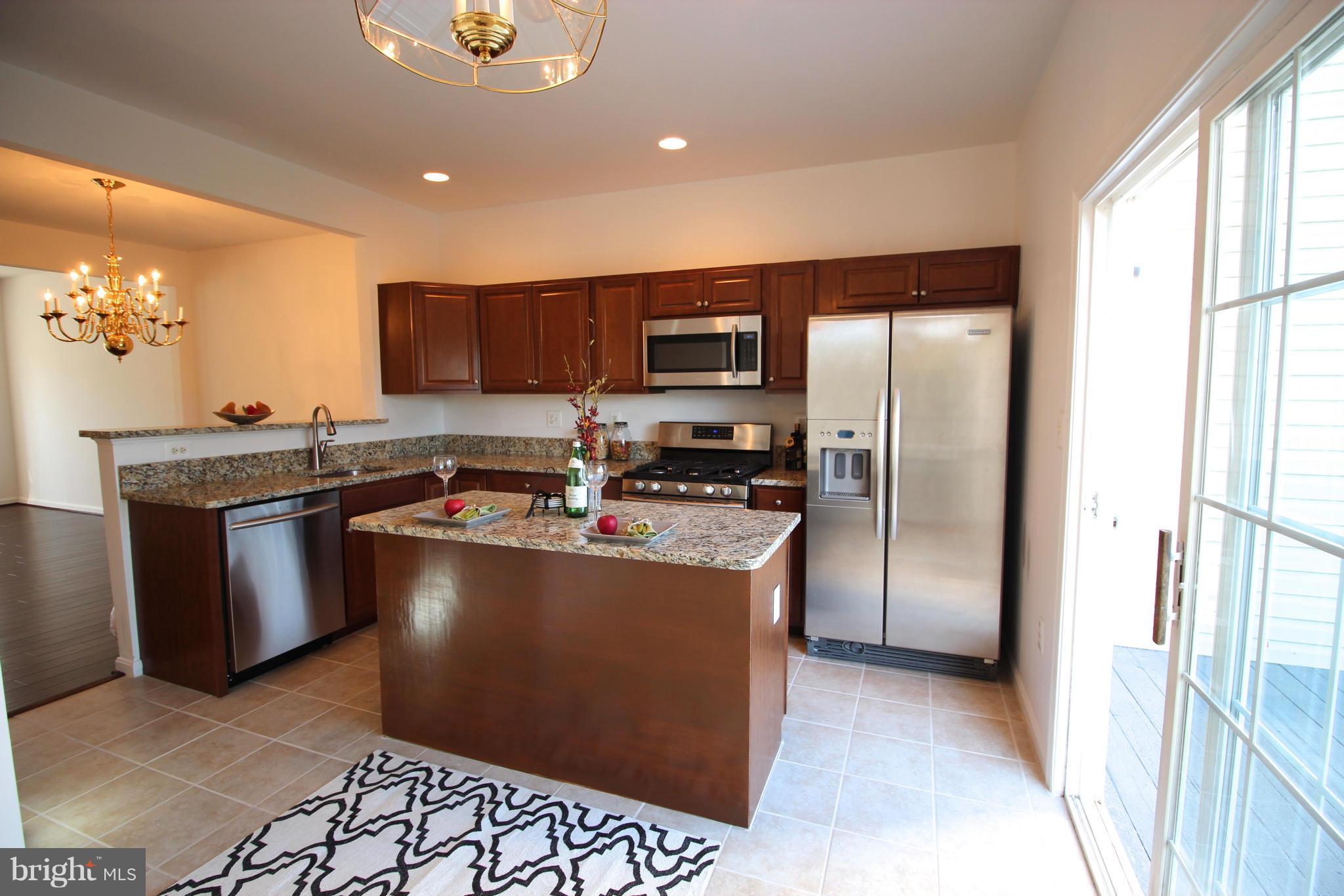 10556 Falkirk Way Manassas, VA 20109 - Photo 6 of 23 a kitchen with stainless steel appliances granite countertop a refrigerator a stove a sink and a microwave