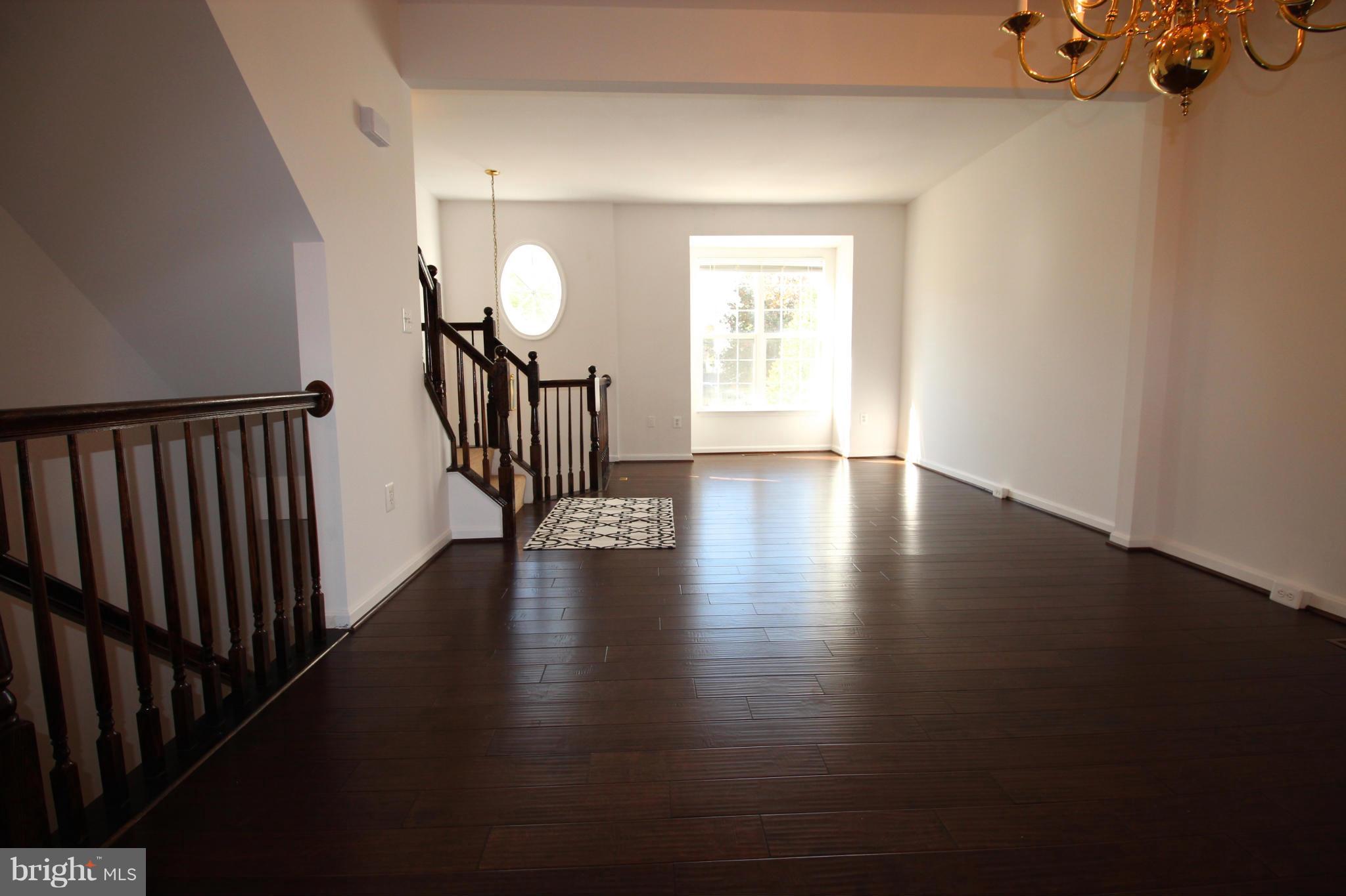10556 Falkirk Way Manassas, VA 20109 - Photo 10 of 23 a view of a livingroom with wooden floor and staircase