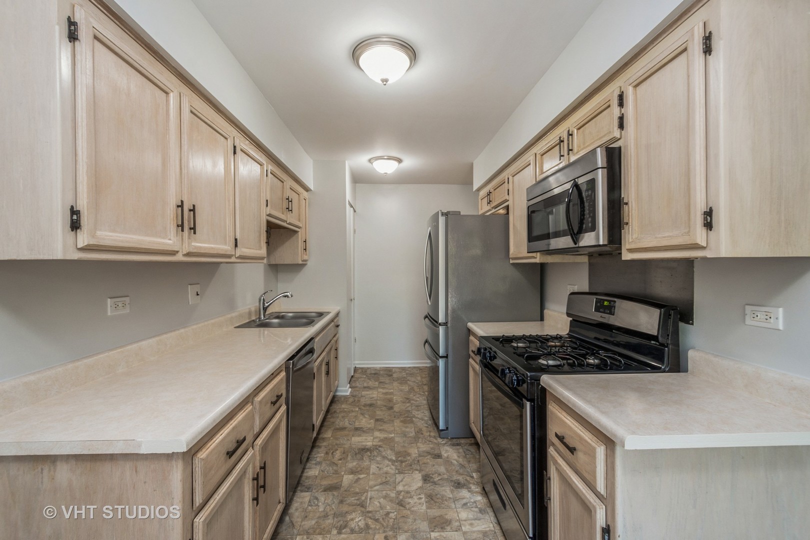 900 South Laflin Street Chicago, IL 60607 - Photo 5 of 20 a kitchen with stainless steel appliances a stove microwave and sink
