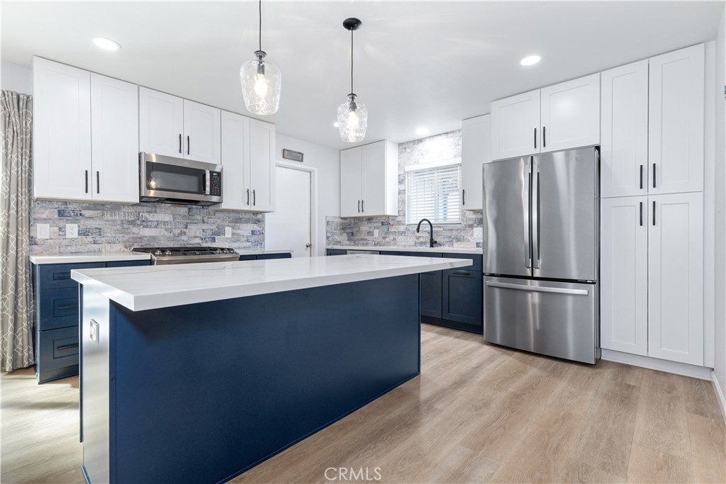 8425 Azucena Avenue Atascadero, CA 93422 - Photo 13 of 47 a kitchen with stainless steel appliances granite countertop a refrigerator a stove a sink and a microwave