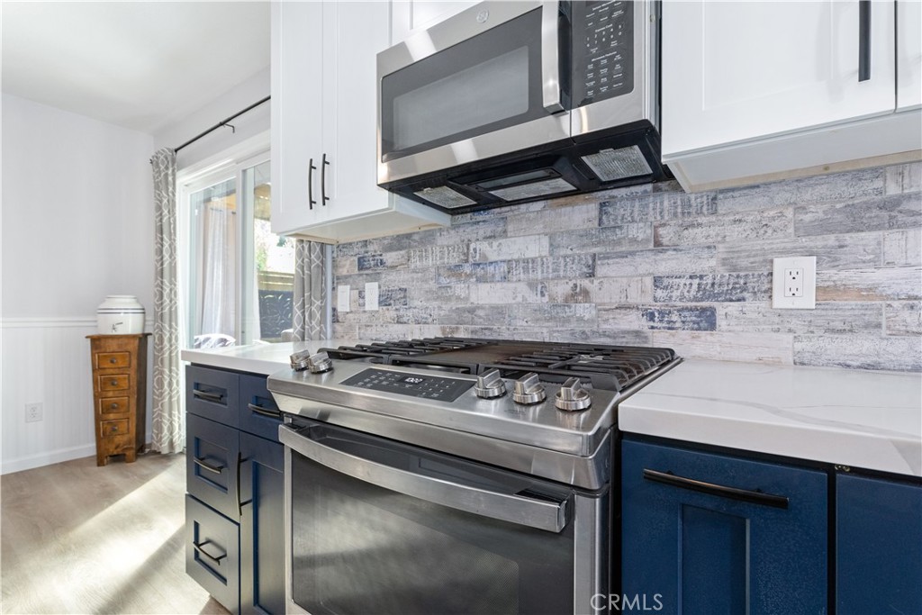 8425 Azucena Avenue Atascadero, CA 93422 - Photo 15 of 47 a stove top oven sitting inside of a kitchen