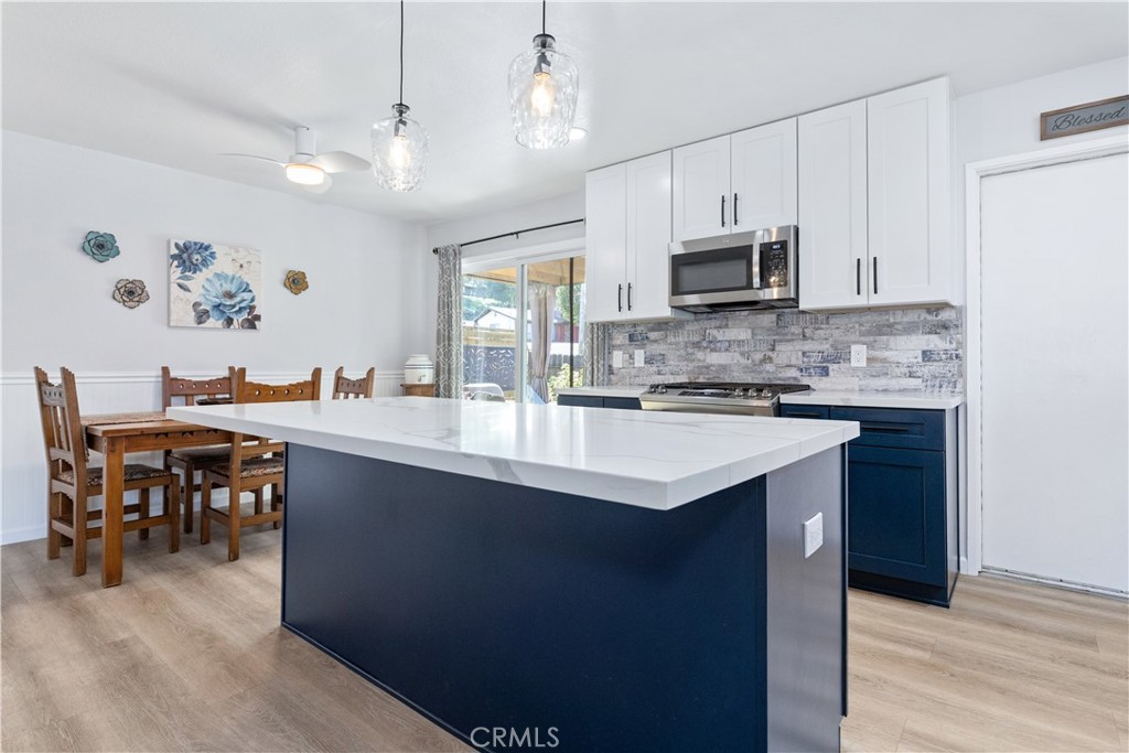8425 Azucena Avenue Atascadero, CA 93422 - Photo 19 of 47 a kitchen with kitchen island granite countertop a sink cabinets and stainless steel appliances