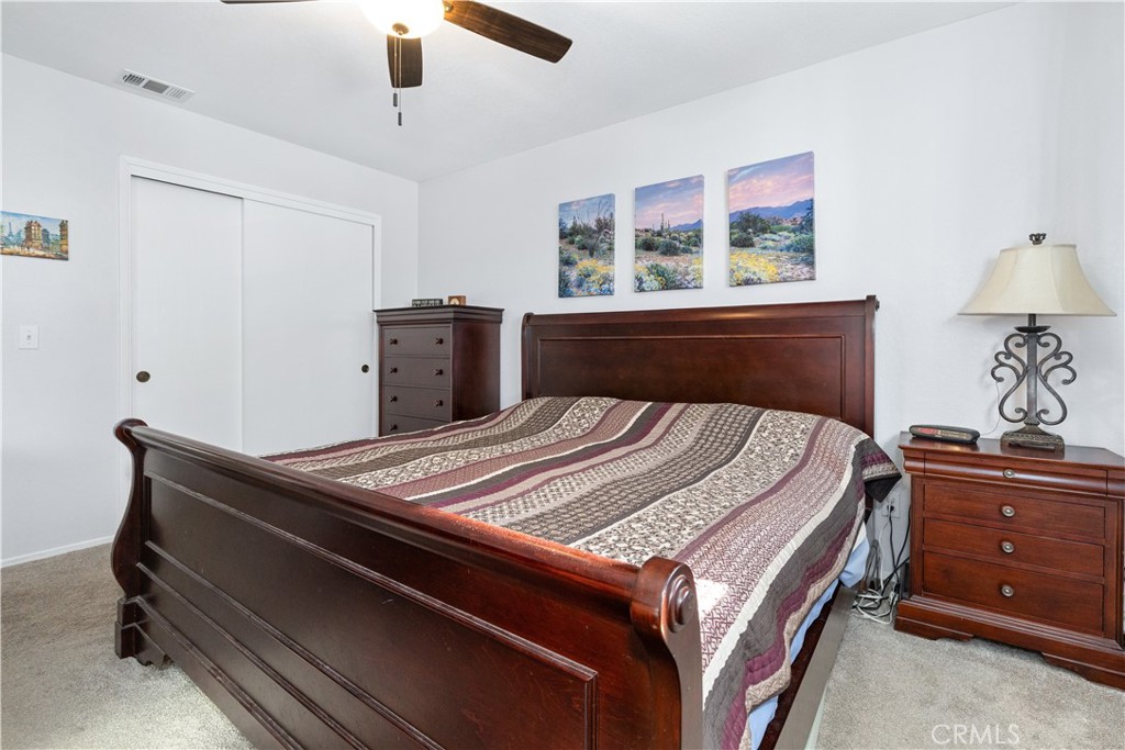 8425 Azucena Avenue Atascadero, CA 93422 - Photo 29 of 47 a bed sitting in a bedroom next to a window and a chandelier