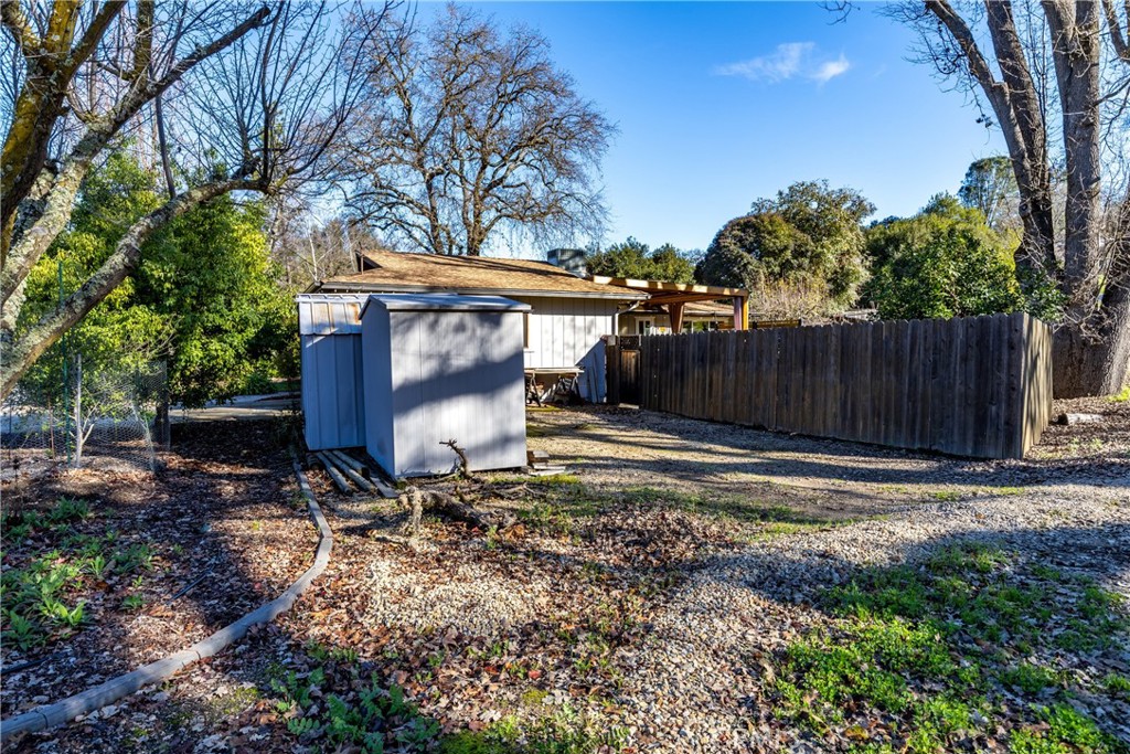 8425 Azucena Avenue Atascadero, CA 93422 - Photo 38 of 47 a view of a backyard with large trees and wooden fence