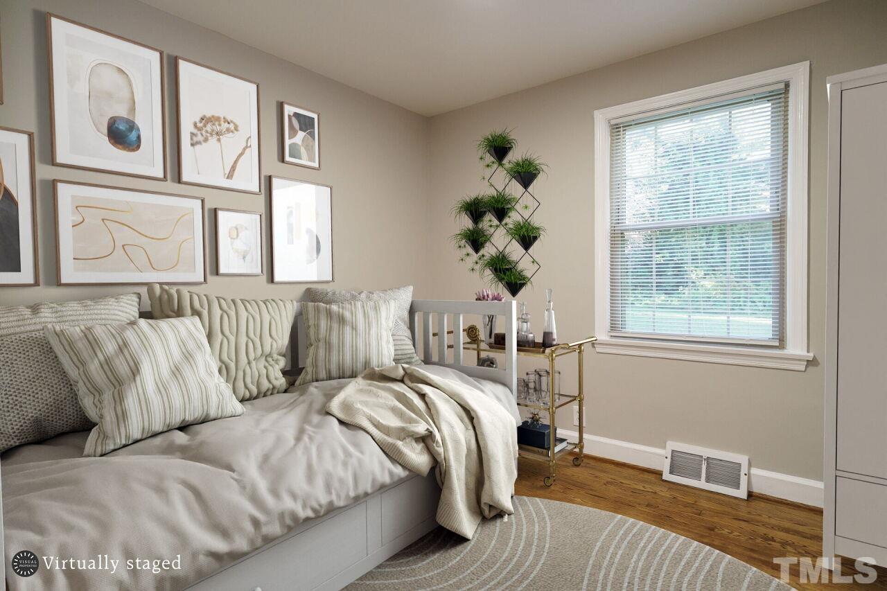 141 Lord Ashley Road Raleigh, NC 27610 - Photo 20 of 28 a bed sitting in a bedroom next to a window