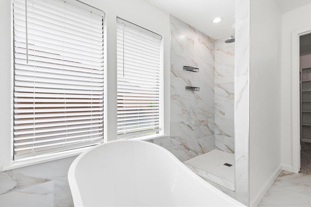 17003 Davenport Road Dallas, TX 75248 - Photo 24 of 40 a bathroom with a bathtub and a shower
