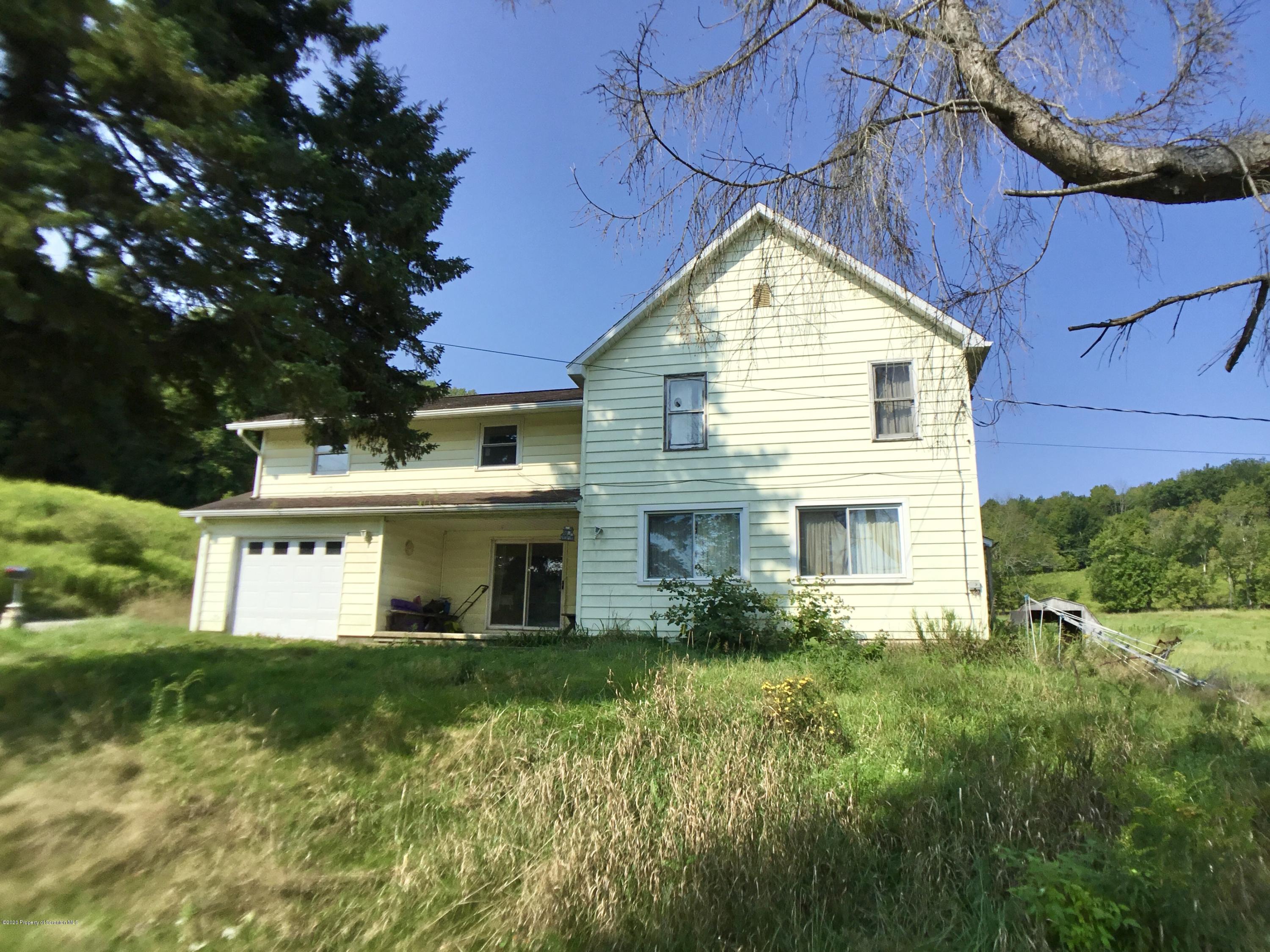 1059 Mountain Valley Road Hallstead, PA 18822 - Photo 1 of 30 a house view with a garden space