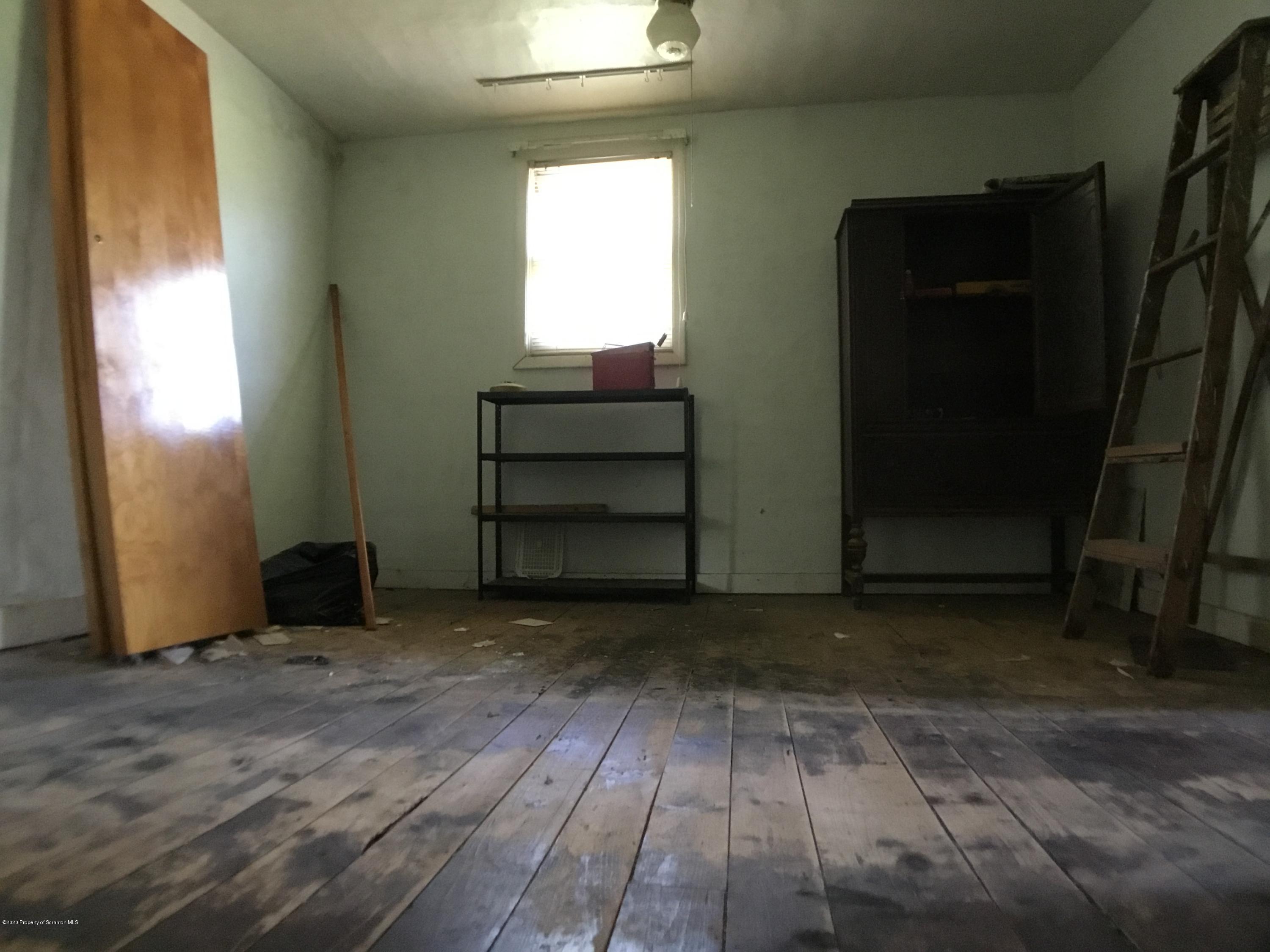 1059 Mountain Valley Road Hallstead, PA 18822 - Photo 24 of 30 an empty room with wooden floor and windows