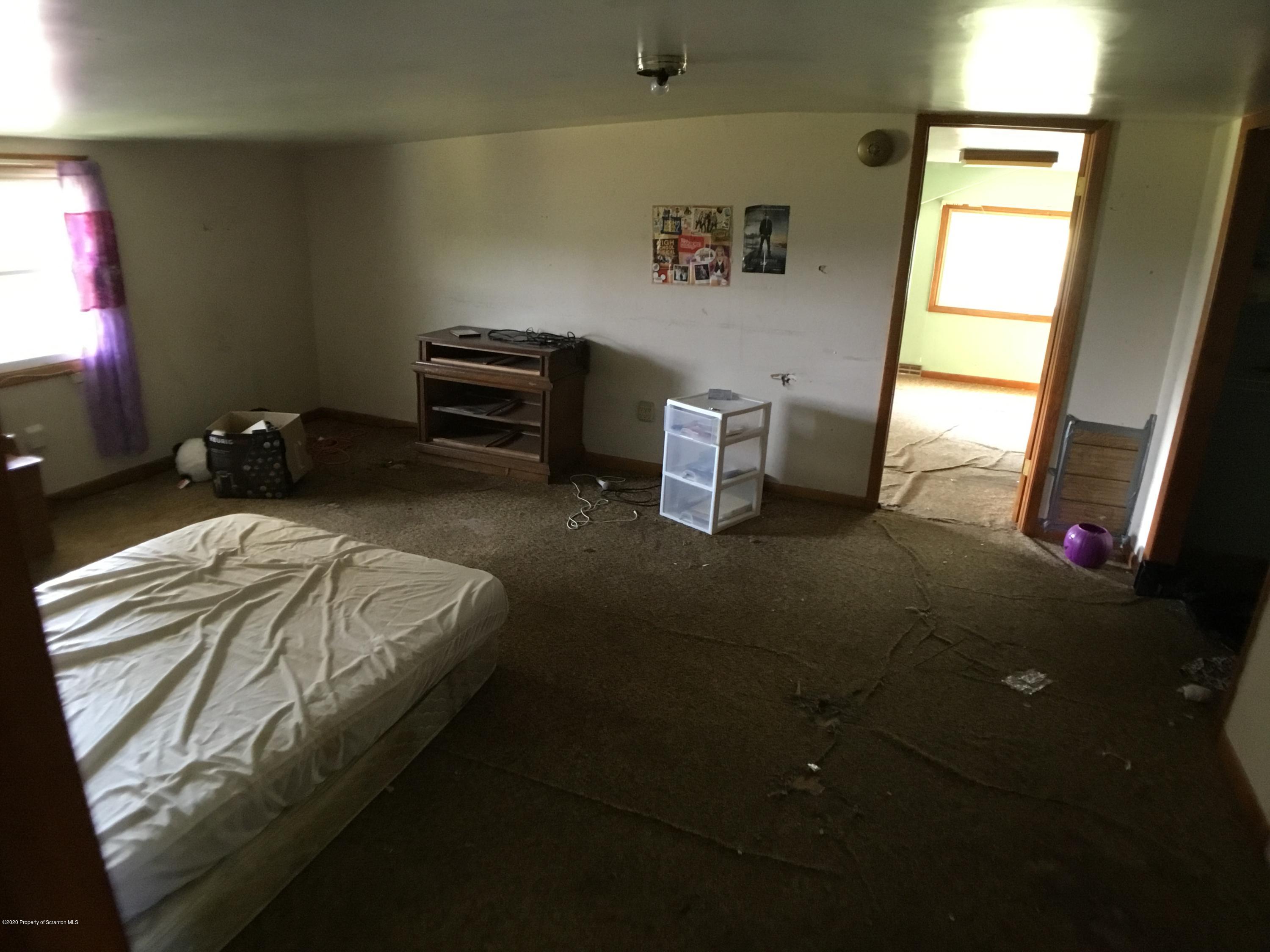 1059 Mountain Valley Road Hallstead, PA 18822 - Photo 25 of 30 a bedroom with a bed and a window