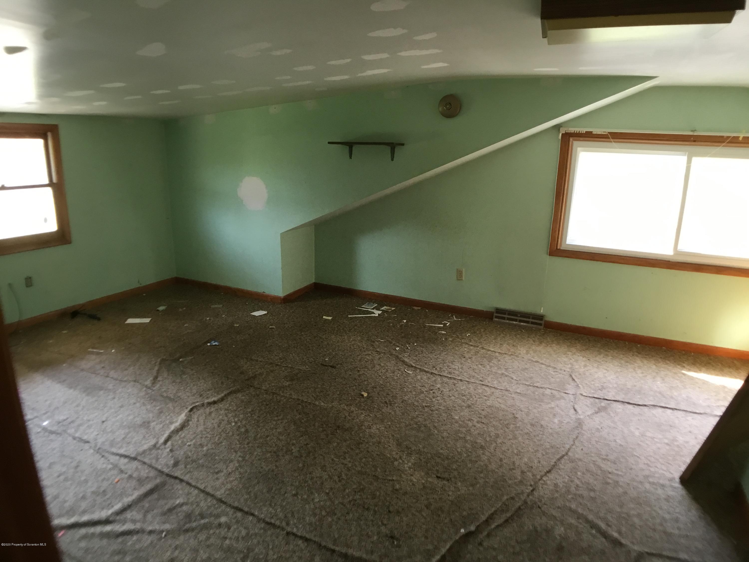 1059 Mountain Valley Road Hallstead, PA 18822 - Photo 27 of 30 a view of an empty room with a window and wooden floor