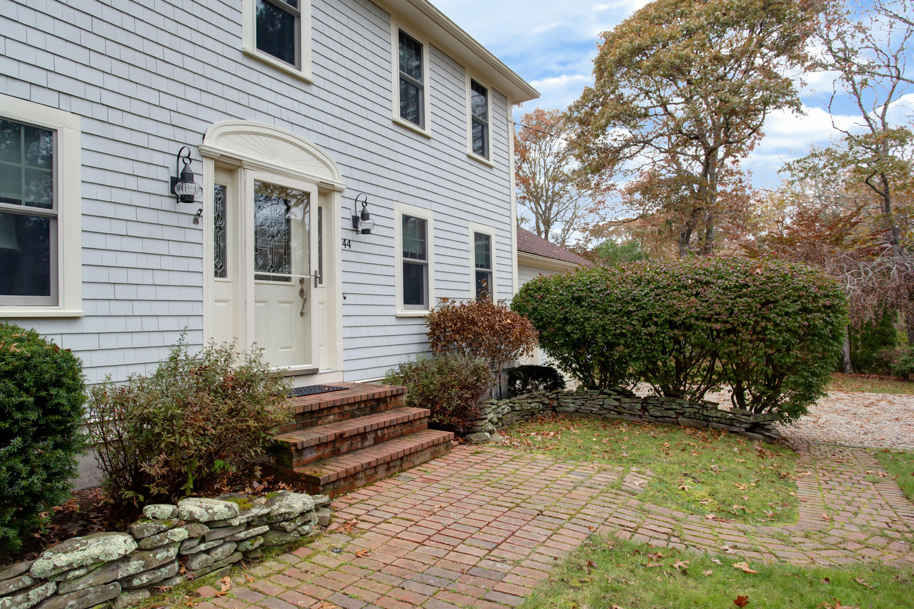 44 Monument Neck Road Bourne, MA 02532 - Photo 3 of 31 a backyard of a house with plants and trees